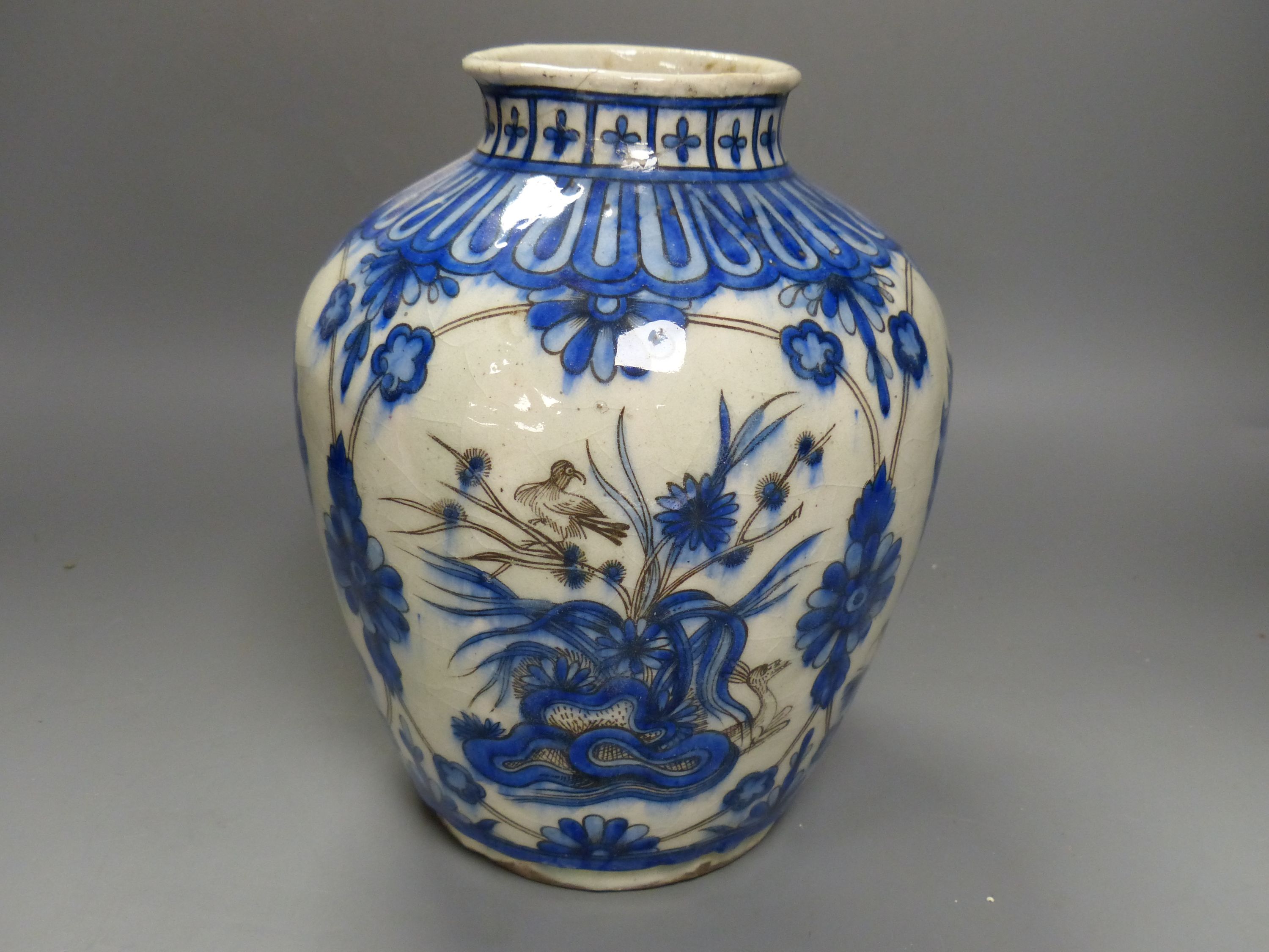 A 19th century Persian Safavid style pottery vase, height 25cm